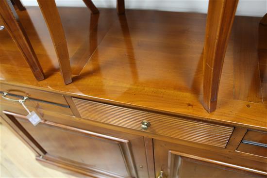 A 20th century French cherrywood radially extending dining table, the circular table extends to 6ft 7in.